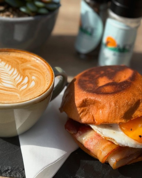 A delicious coffee and bacon and egg roll from The Cafe in Shoal Bay