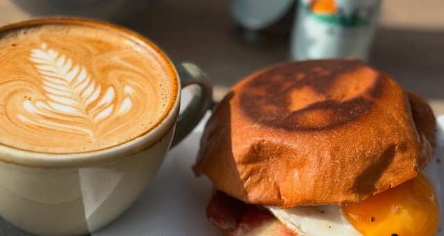 A delicious coffee and bacon and egg roll from The Cafe in Shoal Bay